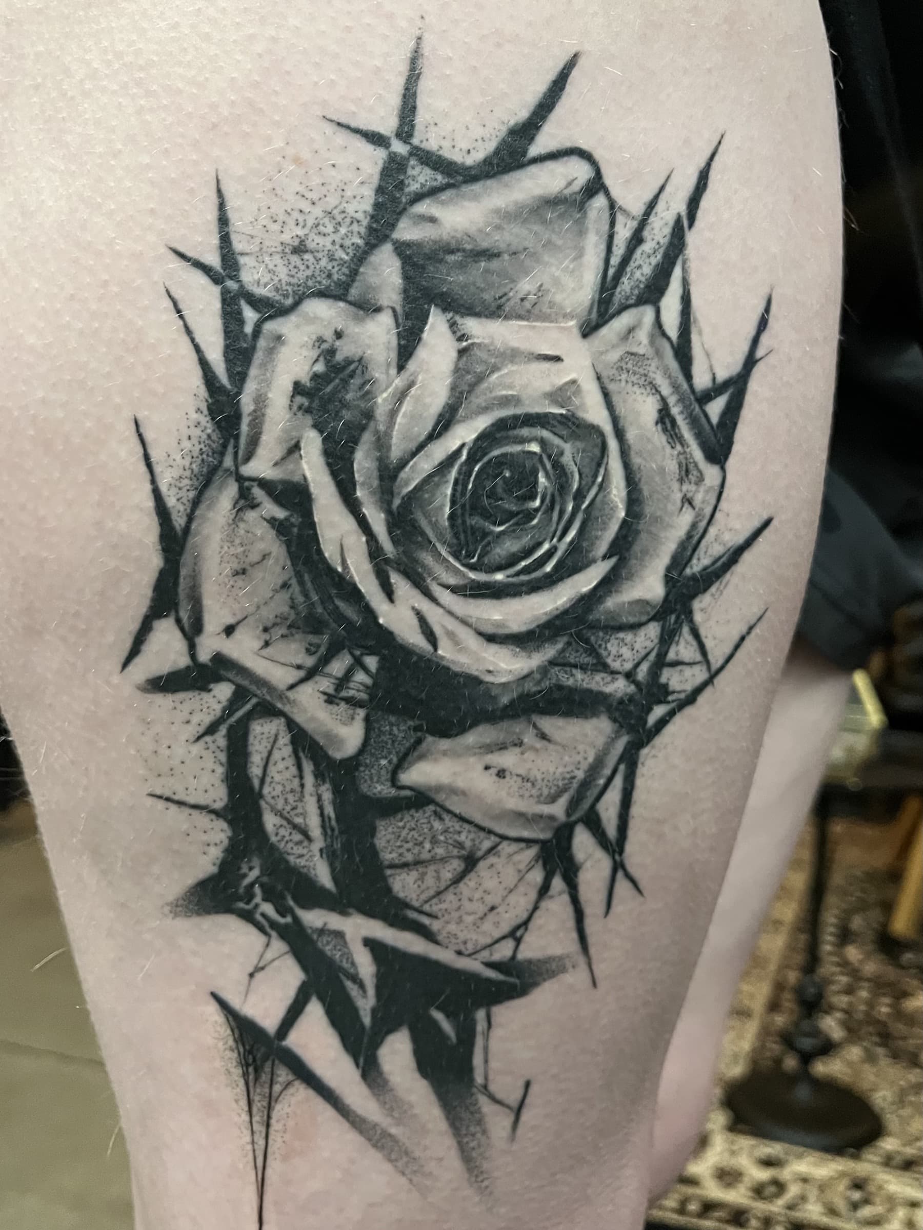 Healed black and grey rose tattoo by Pete Seyring.